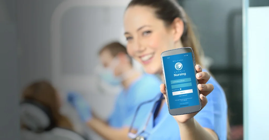 Nursing students holding mobile phone with UWorld Nursing app.