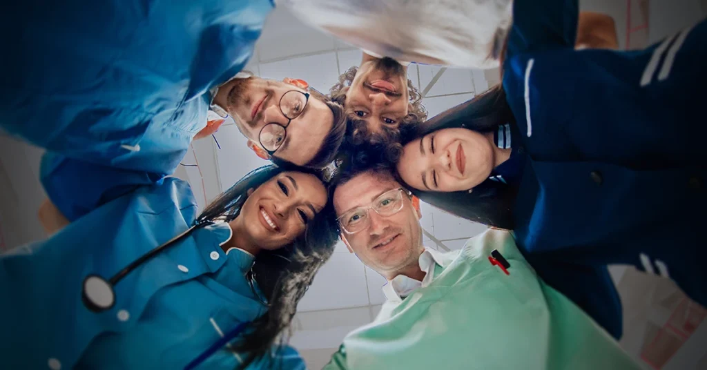 Group of diverse nurses with their heads together