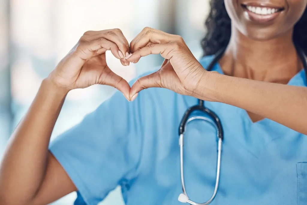 Nurse making heart shape with hand