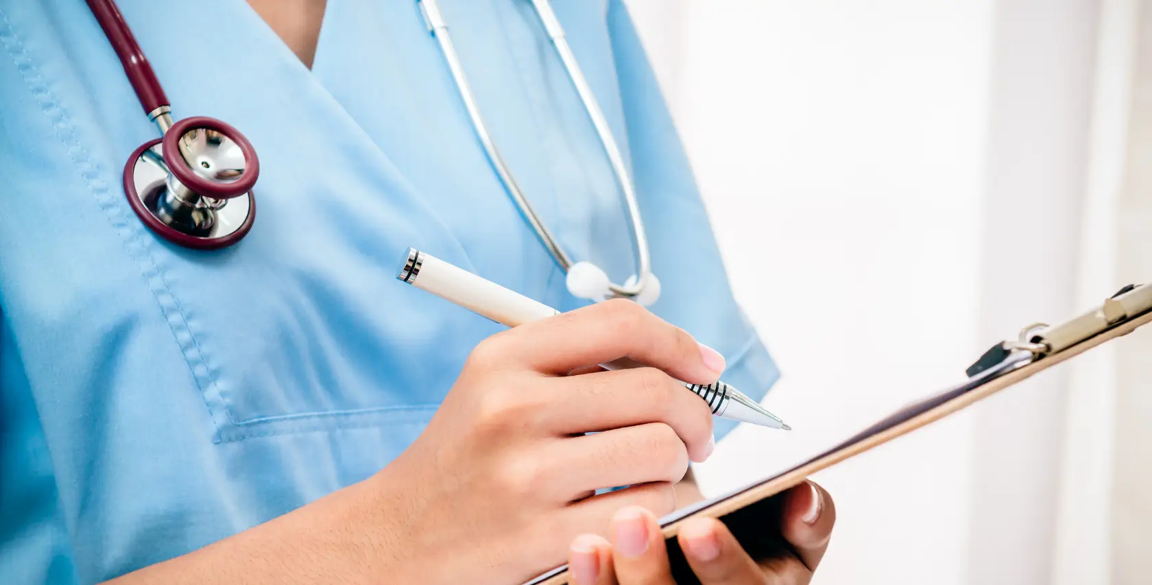 Nurse takes notes during her CCNE accredited clinical practice experience