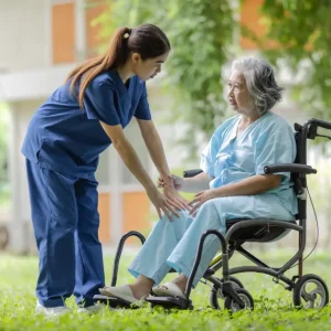 A nurse assists an elderly woman